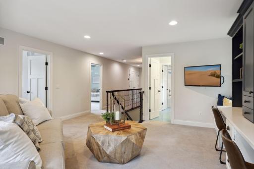 The upper level hosts a spacious loft for media or homework zone, luxurious primary bedroom, two junior bedrooms, and a laundry room with ample storage.