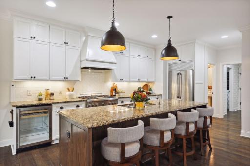Create a culinary experience for your guests. You will love this spectacular gourmet kitchen with crisp white enameled cabinets, granite countertops and stainless-steel appliances.