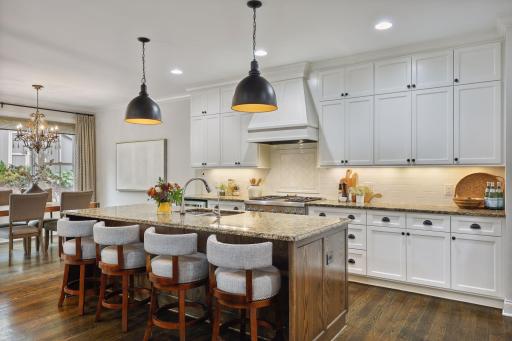 No detail was missed in this gourmet kitchen, featuring high-end appliances, designer tile backsplash, and center social island.