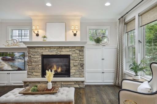 Flanked by built-in media cabinets, the stone fireplace creates year-round ambiance of comfort and style.