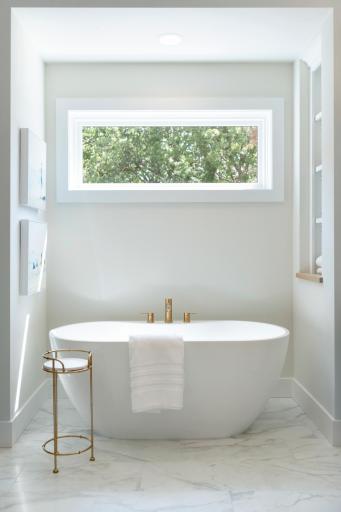 Gold plumbing fixtures warm up the space even more