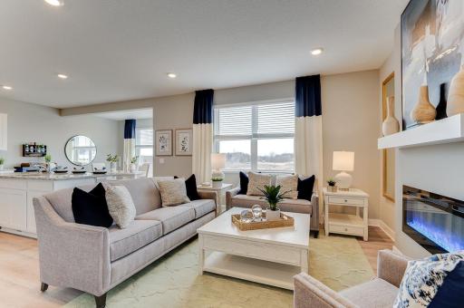 Welcome to the Pine. A look at the main level family room, which flows conveniently with the rest of the space provided in this charming layout! (Photos of the same floorplan, colors are similar)