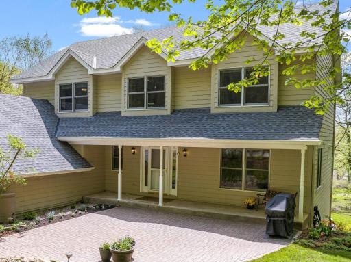 Charming covered front porch and large patio to welcome friends and family.