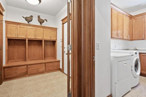 Mudroom with custom built ins welcomes you with plenty of space for coats & backpacks
