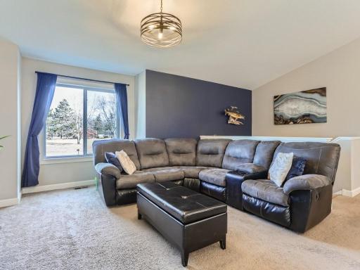 The spacious living room offers plenty of space for family time or for entertaining.