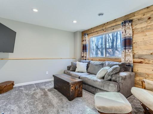 The lower level family room features a beautiful wood accent wall.