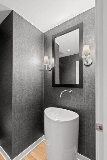 A newly remodeled main level powder room with Bocci Sink and custom wallcovering