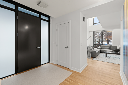 The entrance foyer features privacy glass and double coat closets