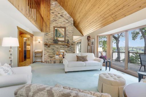 Two story great room with see thru fireplace and huge bay window overlooking deck.