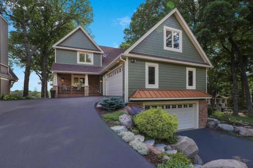 Walkout two story on treed lot with 62 feet of lakefront on Lotus!