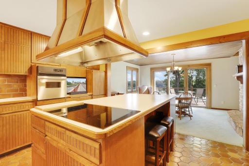 Center island kitchen with tiled floors and upgraded appliances.
