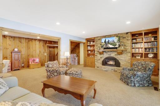 Huge family room & amusement area with fireplace, bookcases and sliding doors to patio.