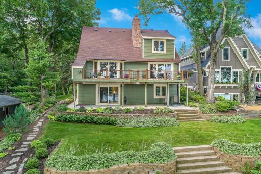 Beautifully landscaped yard extending to the lakefront. Huge upper deck and spacious patio with eastern views over Lotus Lake.