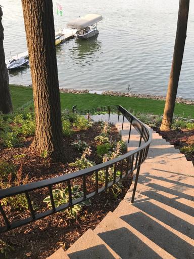 Steps and landscaping down to lakefront and sitting area.