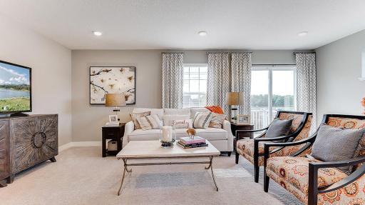 Large windows give the family room an airy and open feel. Model shown. Colors and finishes may vary.