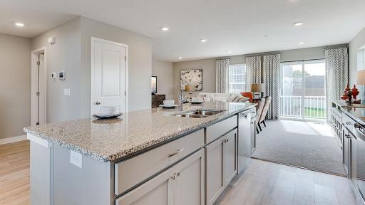 Large island in the kitchen opens right up to the family room. Model picture shown. Colors and finishes may vary.