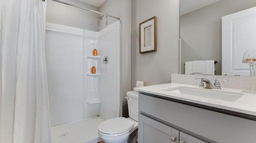 Attached primary bath to the main bedroom. Model shown. Colors and finishes may vary.