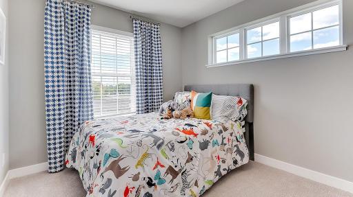 Bedroom 3 of 3 all on one floor. Large windows give the room an open airy feel. Model shown. Colors and finishes may vary.