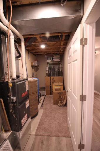 Other end of utility room with new high efficiency furnace and ac. The water heater is electric. There is a whole house water filtering system. There is a sump pit but it has no pump or piping because there has been no water that seller knows of.