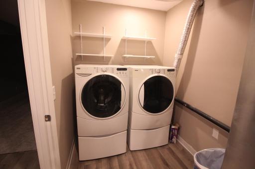 One end of the 19'x6' laundry/utility room. Kenmore front load washer & electric dryer on pedestals.