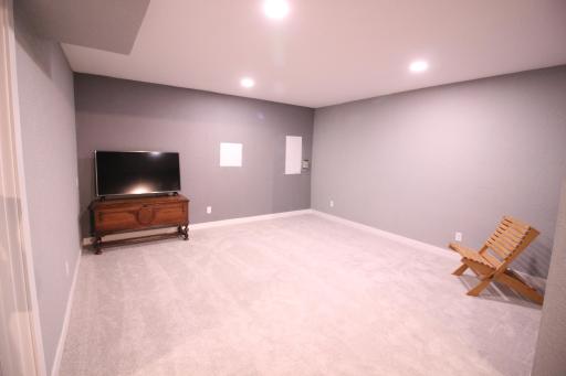 14' x 14' lower level family room. New carpet with canned lights in the ceiling on a dimmer switch for mood lighting levels.