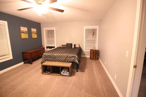 19' x 14' large master bedroom with new carpet.