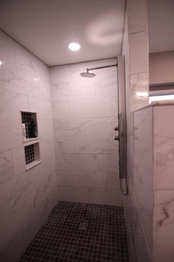 Close up of the custom built roll-in tiled shower.
