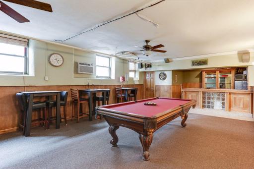 Association shared amusement room with bar, bathroom, pool table and tons of space for hosting.