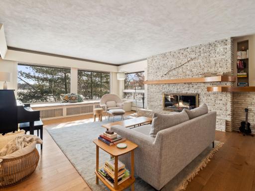 Expansive living room with window seats to and wood fireplace