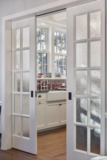 Traditional details to include these french slider doors create a separation from the dining room when you are entertaining.
