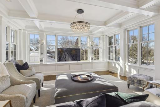 A window lined family room offers gorgeous views of Lake Harriet. What an amazing space and it opens into the kitchen. This is a well loved living space and the views are awesome.