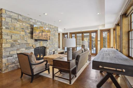 The lower level entertainment space. Check out this stone fireplace. The kids love spending time here and the backyard is right there for them. There is plenty of room for a basketball game on the back driveway.