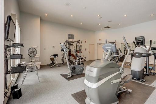 Shared amenities include an enormous workout room, sauna, party room, heated garage, and outdoor heated pool!