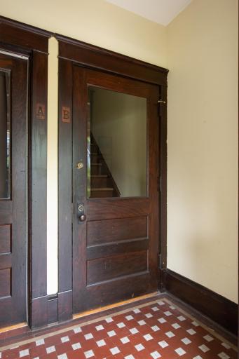 1 of 2 common entry foyers w/ original woodwork and tile - all in excellent condition!