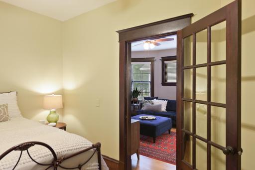 Solid wood French doors are stained to match original woodwork and have curtain rods for privacy when needed.