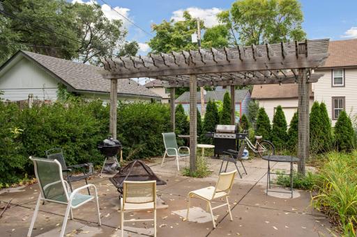Massive pergola on the huge shared patio. Mature cedar trees and lilacs provide privacy and beauty.