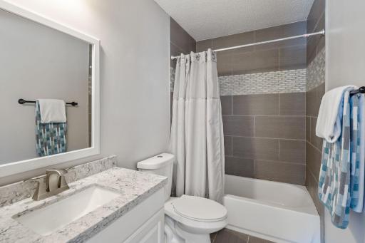 Beautifully updated full bathroom on main level with new quartz countertops