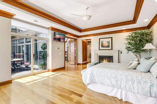 Primary suite with fireplace and sliding door to balcony