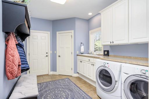 Oversized laundry | mudroom with sink, large closet, and tons of folding space.