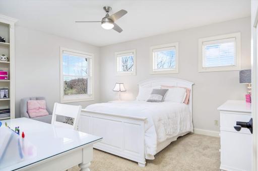 This bright and sunny bedroom with built-in cabinetry has a large walk-in closet and pass-through access to the hall bath.