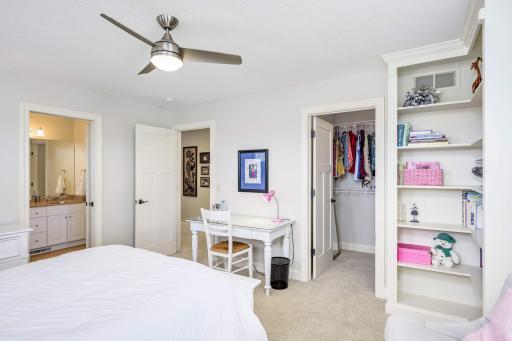 This bedroom is spacious enough for a dresser, desk, and extra seating.