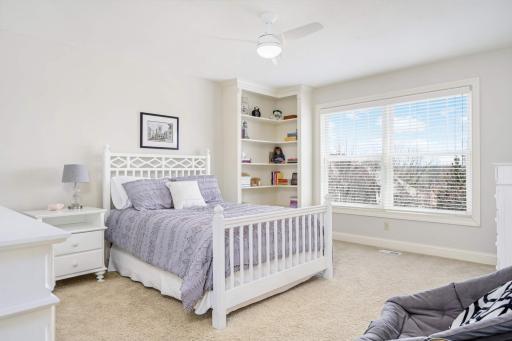 One of four upper-level bedrooms. Thoughtful custom corner-built cabinet and oversized walk-in closet.