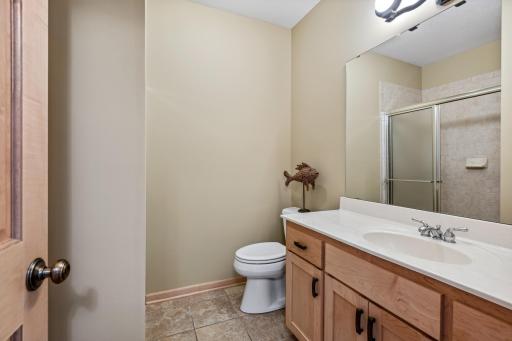 The lower level 3/4 bath is adjacent to the fourth bedroom and amusement room.