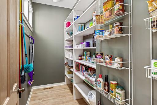 A spacious walk in pantry complete with a window to keep your household organized.