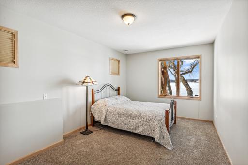 Fourth bedroom is located in the walkout level and overlooks the lake.