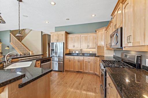 Designed for convenience, this stunning kitchen boasts Silestone countertops and island, NEW Whirlpool stainless steel appliance package with a 5-burner gas range sink and elevated countertops and cabinetry.