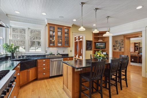 View of kitchen looking into the family room and with glimpses of mudroom and side deck entry