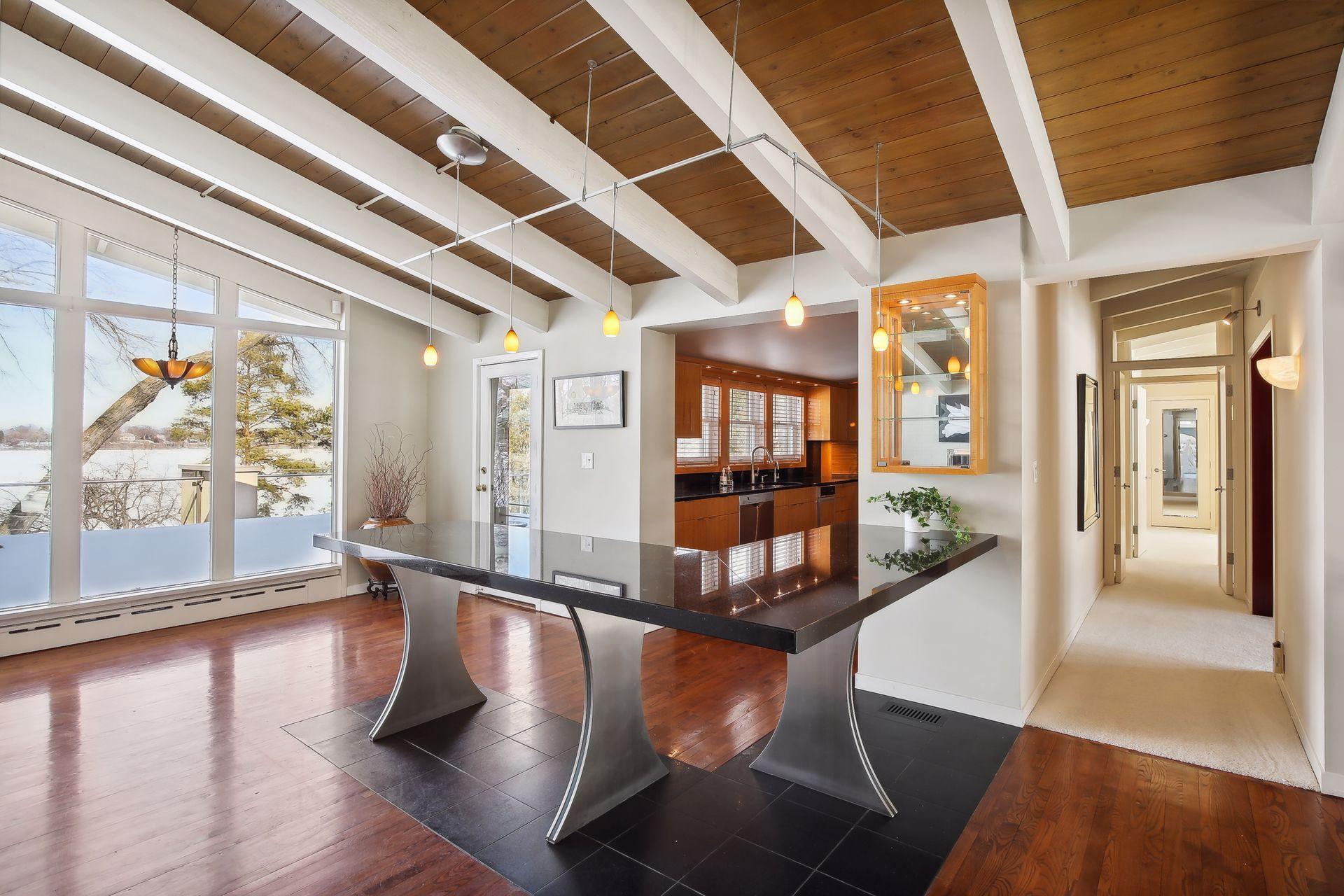 Room in this area for a smaller table and chairs to provide additional dining space while enjoying the lake views