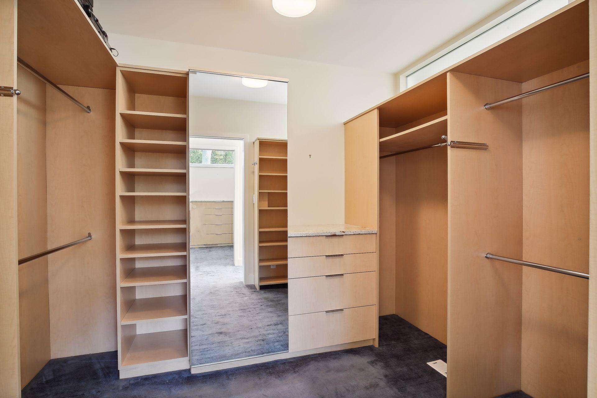 Both walk-in closets offer a thoughtful layout of built-in organizational components