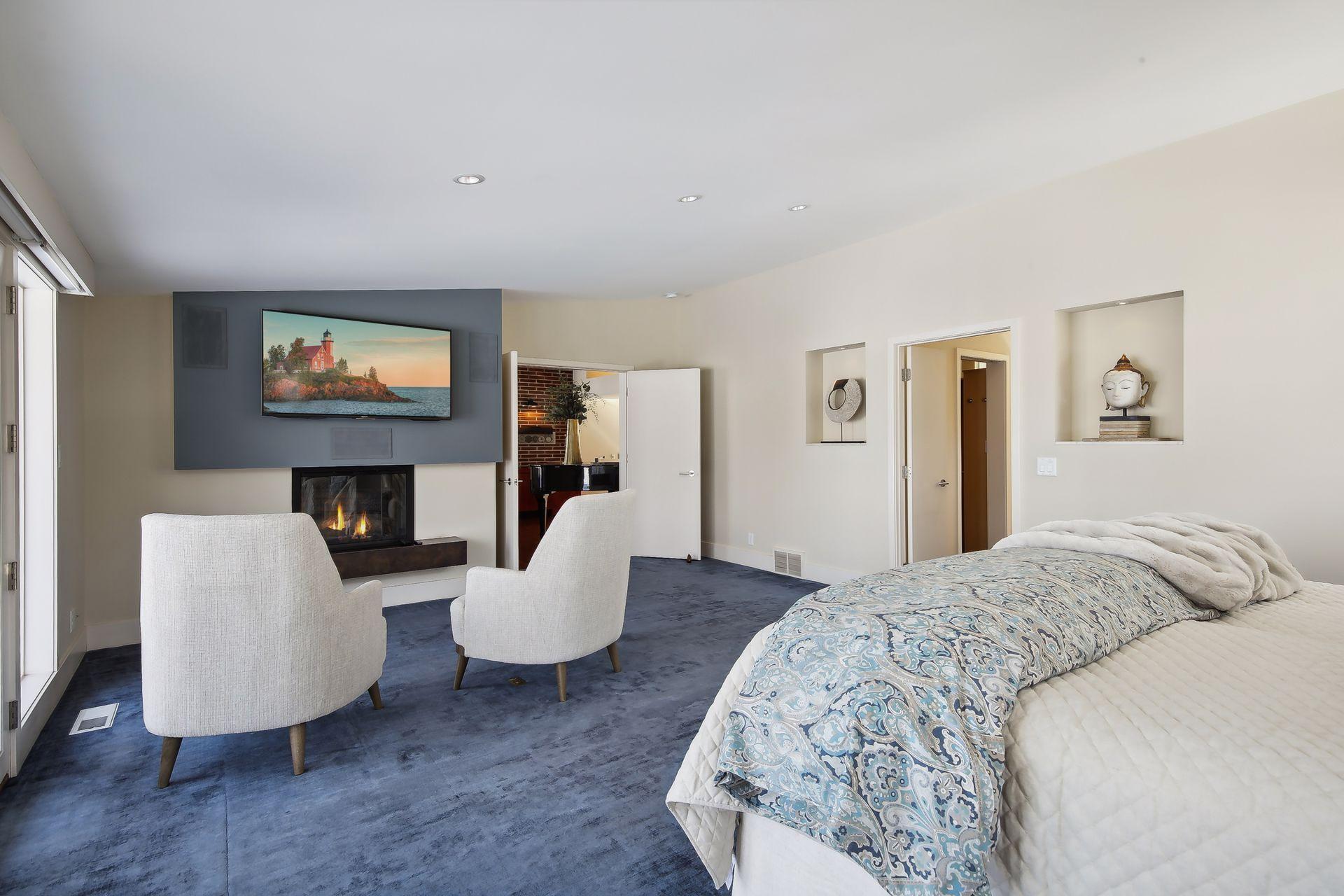 A cozy gas fireplace anchors one end of the bedroom